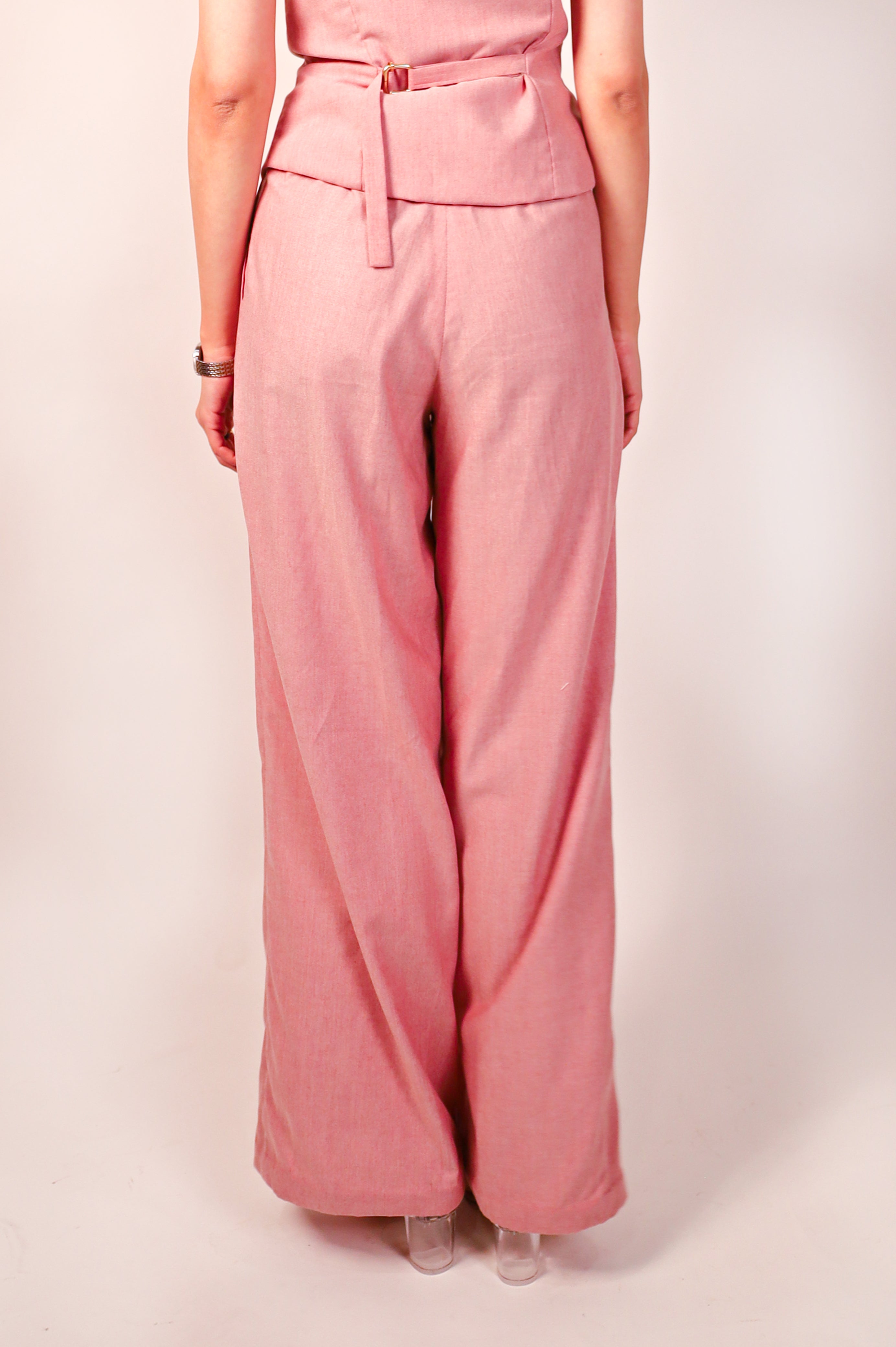 Handmade tailored workwear vest and pant in premium duck voile Person wearing a pink jumpsuit on a plain background back view