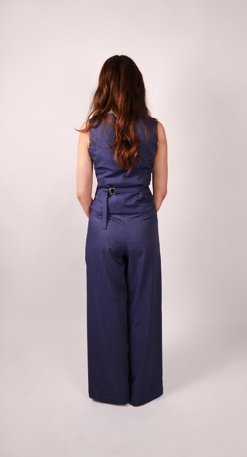 High-quality premium cross-body vest for women and Premium breathable women’s workwear trousers in chambray blue back view